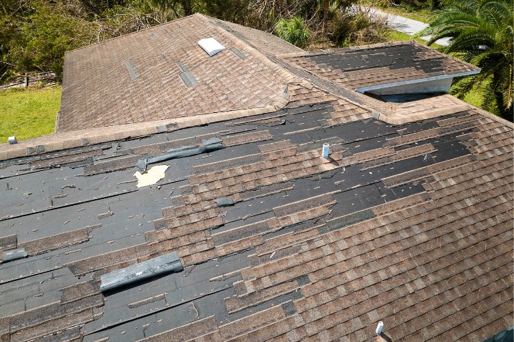 Damaged roof from hurricane force winds in Concord that needs emergency repairs.
