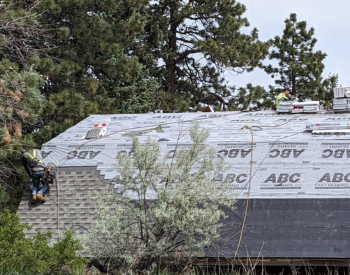 Roofing contractor performing Waknut Creek roof repair during summer on a fire damaged home
