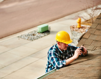 Roofing contractor fixing summer storm damage