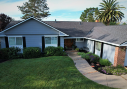Elegant Dublin home showcasing expert roofing with a beautifully maintained lawn and clear skies